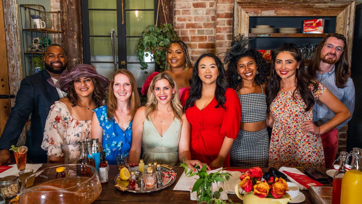 People around table with Luzianne Tea